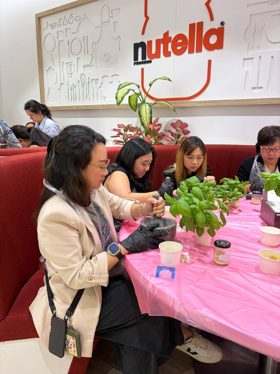 office employees doing a pesto making workshop in the office as part of sustainability, wellness, team building, and engagement.