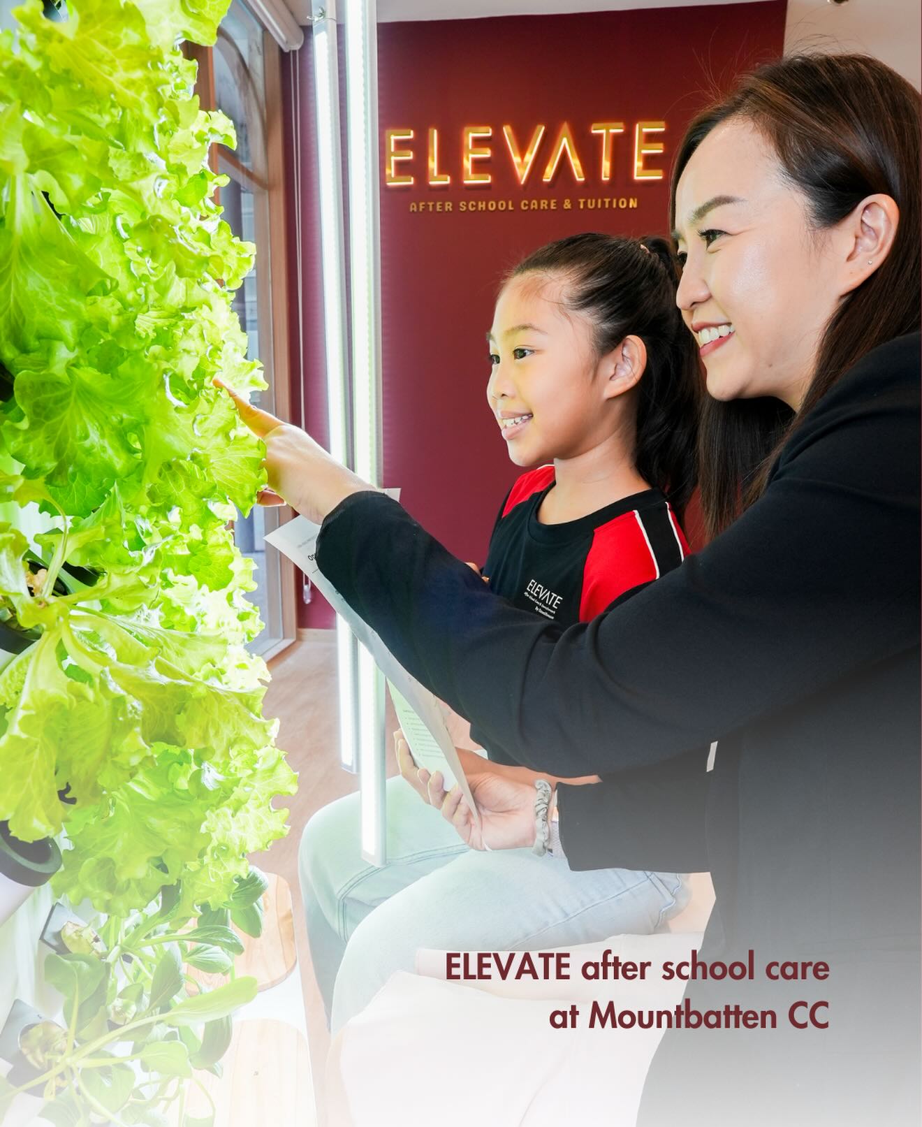 teacher and child interacting with a hydroponic system at an after-school care and tuition cantre